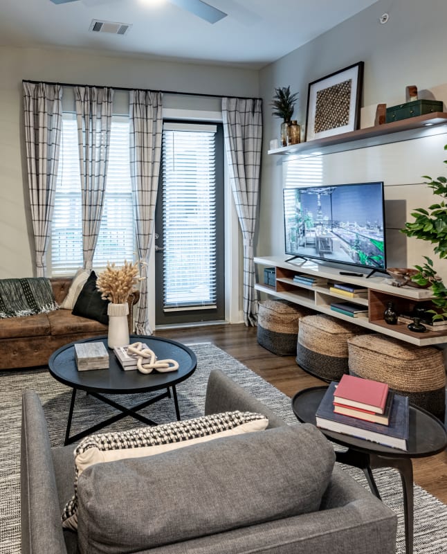 A well-lit and spacious living room in a model home at Fitzroy Grove in Rogers, Arkansas