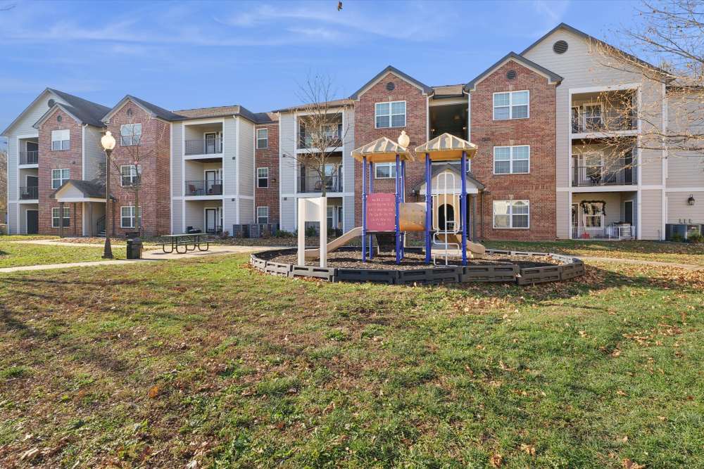 Charming apartments with lush landscaping and a delightful playground at Covington Woods Apartments in Lansing, Kansas.