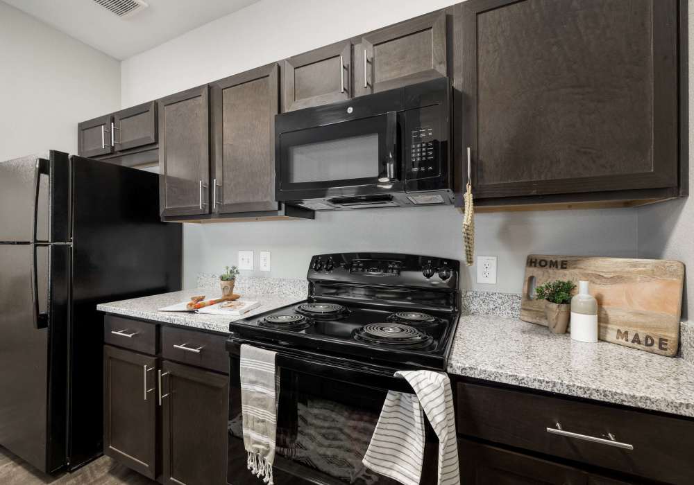 Kitchen with wooden cabinets at Riverstone in San Marcos,Texas