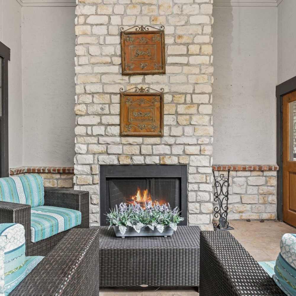 Outdoor patio featuring stone fireplace at Stonebridge at the Ranch Apartments in Little Rock, Arkansas