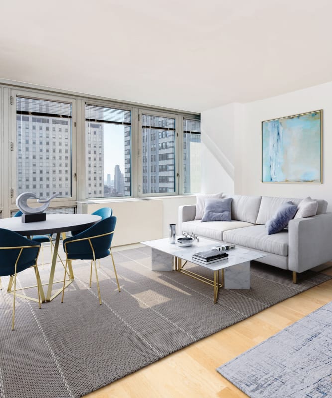 A studio living room with large windows at The Metropolis in New York, New York