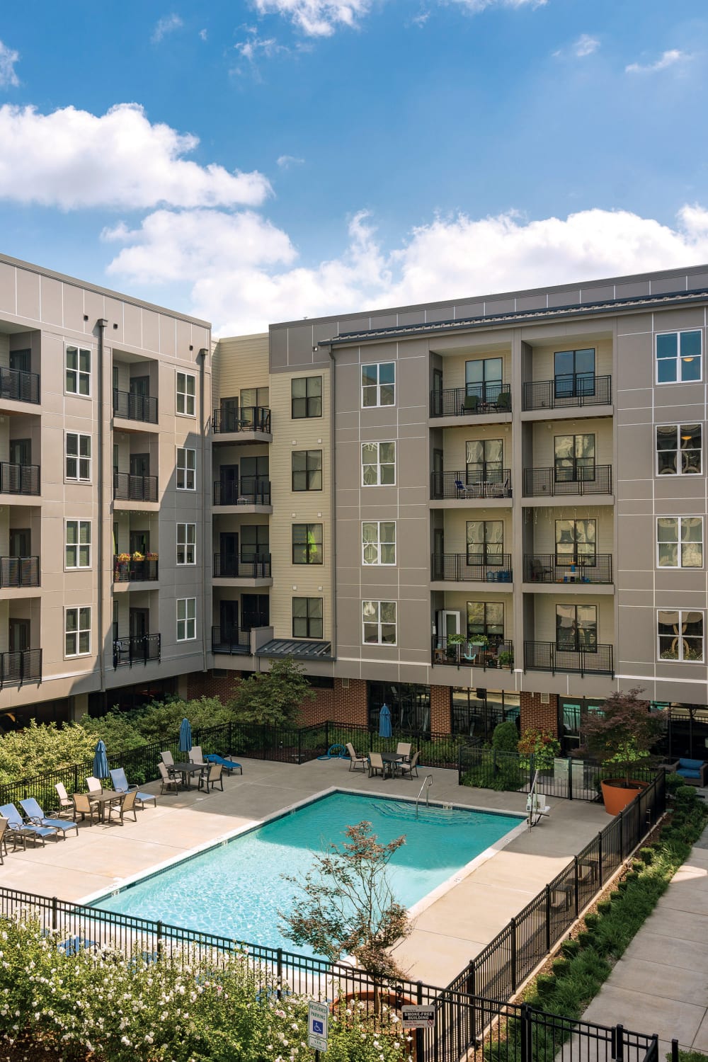 Exterior of the apartment building with a swimming pool at The Residences at Harlan Flats in Wilmington, Delaware