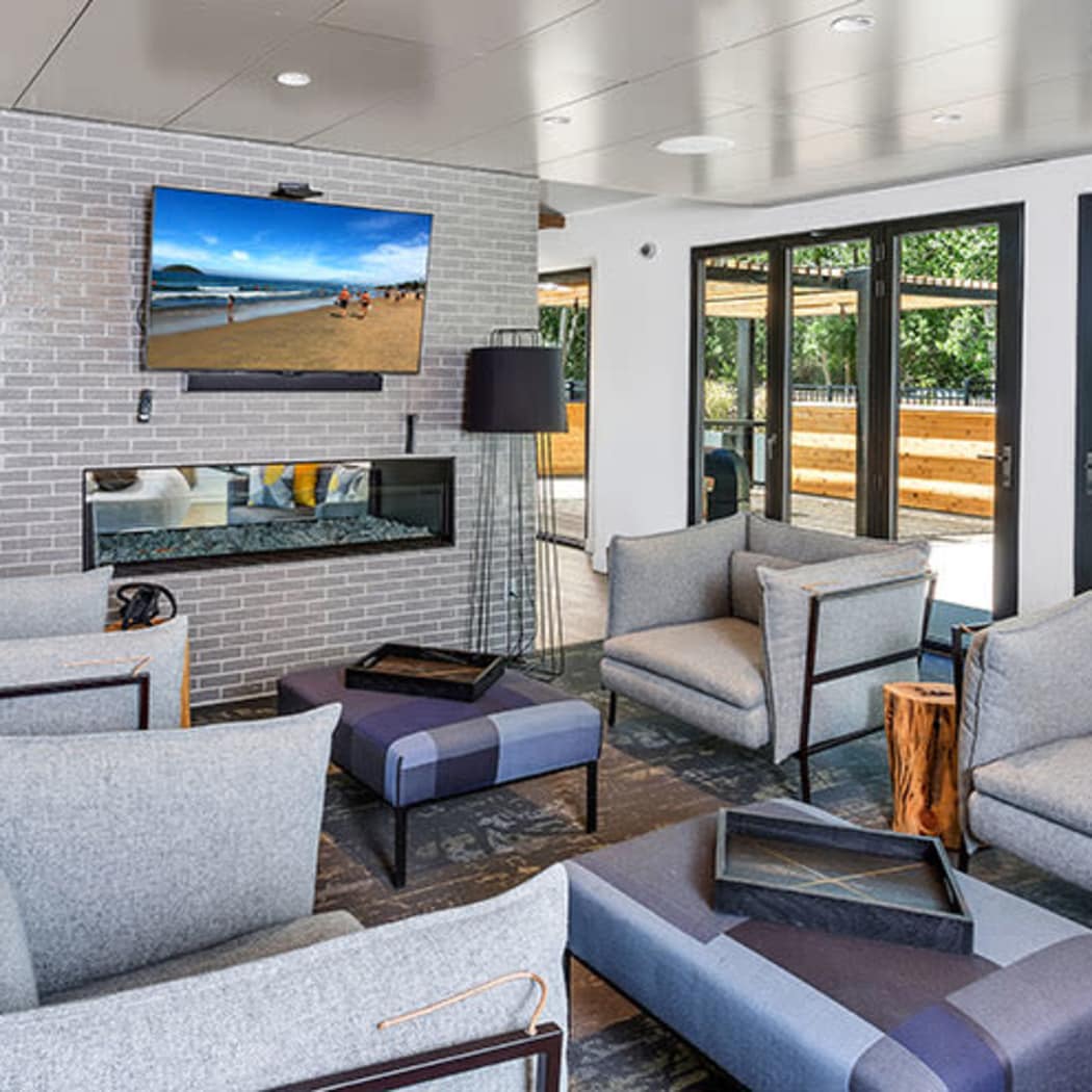 Community lounge with TV at TAVA Waters in Denver, Colorado