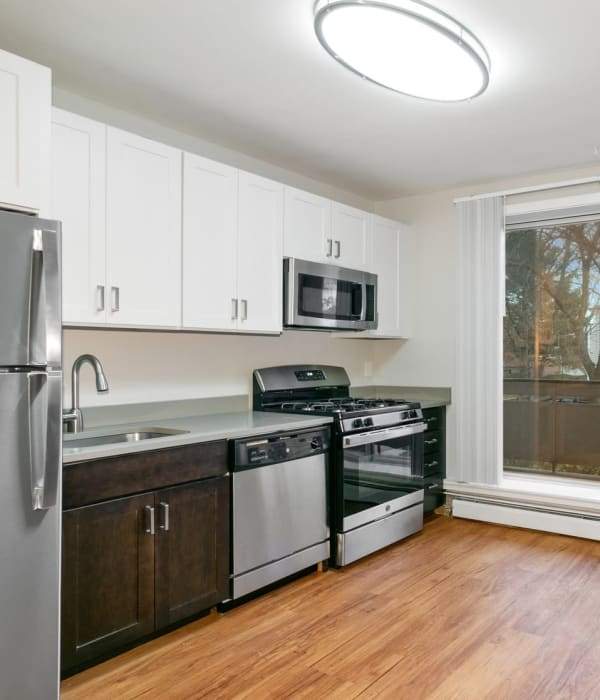 Kitchen with quick access to patio at Eagle Rock Apartments & Townhomes at Brighton in Brighton, Massachusetts