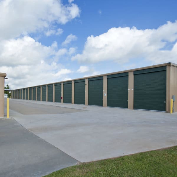Outdoor storage units with green doors at StorQuest Self Storage in Stockton, California