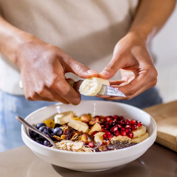 A resident making a healthy breakfast at Station 21 Apartments in Mesa, Arizona