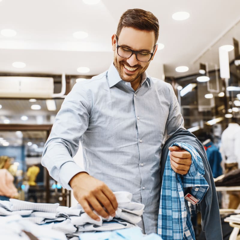 Man shopping for shirts in a men's clothing retailer at Portside Ventura Harbor in Ventura, California