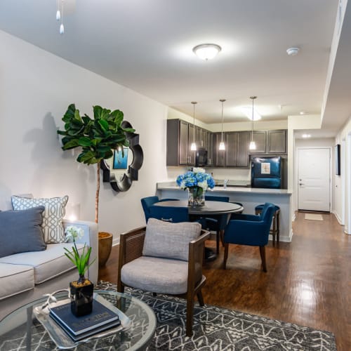 Kitchen, dining, and living area of an open concept model apartment at Glenmoor Oaks in Moseley, Virginia