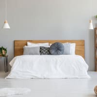 Modern designed bedroom with large bed and lots of pillows at Decker Apartment Homes in Ft Worth, Texas