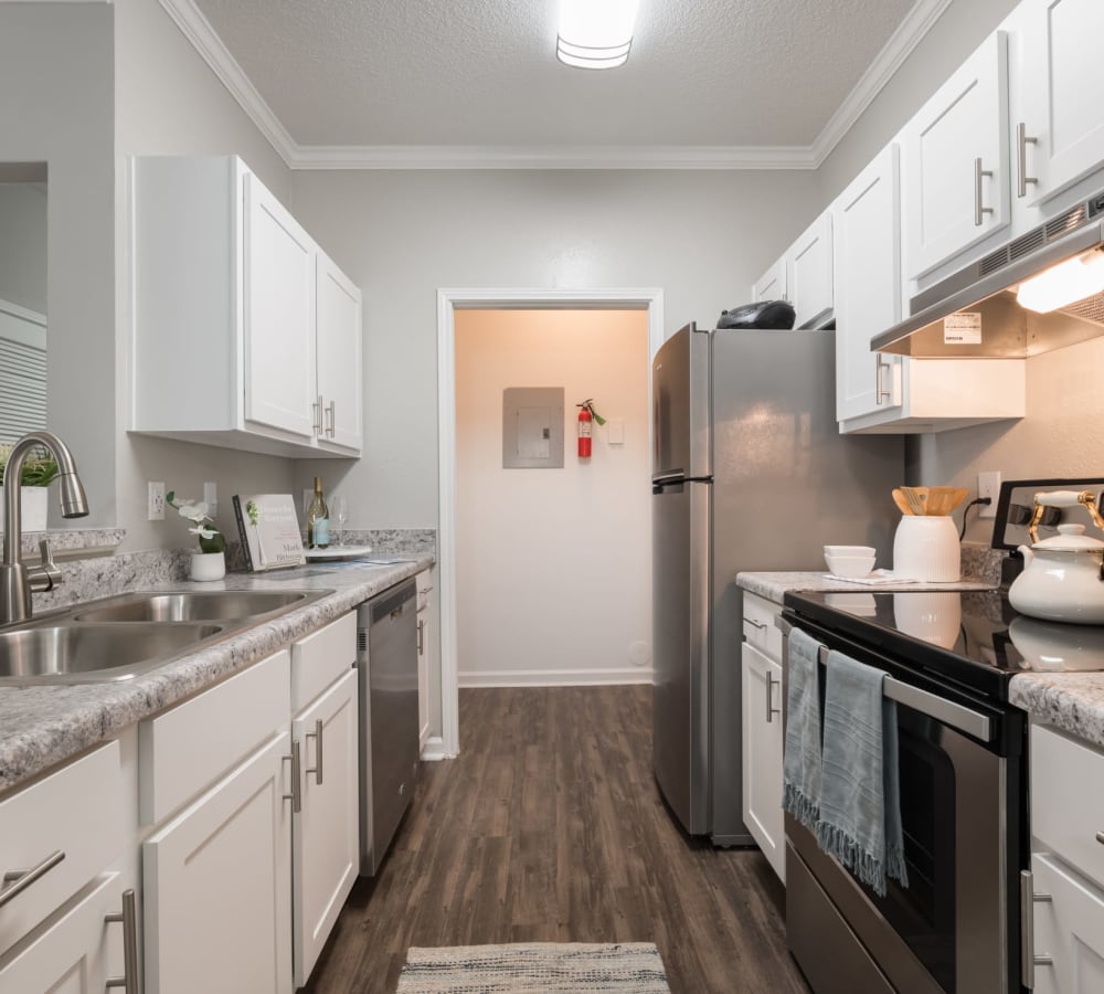 White cabinets and stainless steel appliances in an apartment kitchen at Chace Lake Villas in Birmingham, Alabama