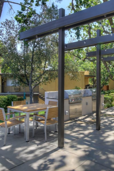 Barbeque area with table and chairs at Los Robles Apartments, Thousand Oaks, California