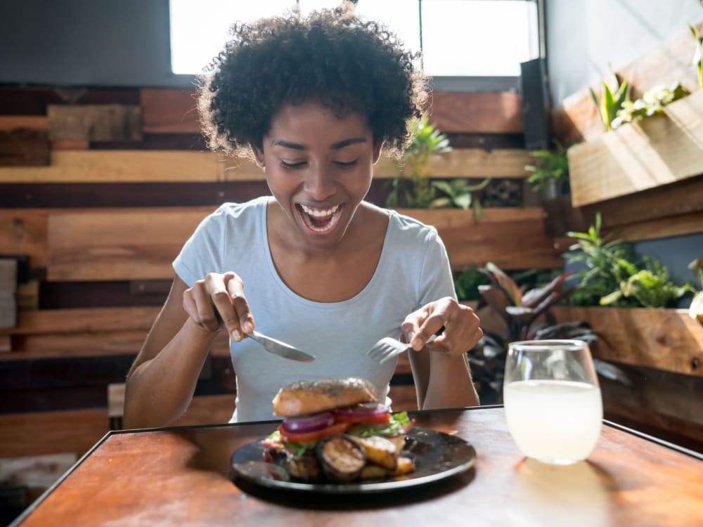 Woman about to dig in to a delicious burger near Sanctuary on 51st in Laveen, Arizona