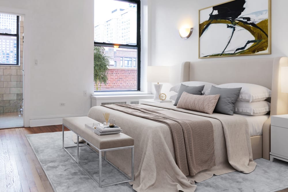 Large bedroom with wood-style flooring and a large window with a view at The Sutton Collection in New York, New York