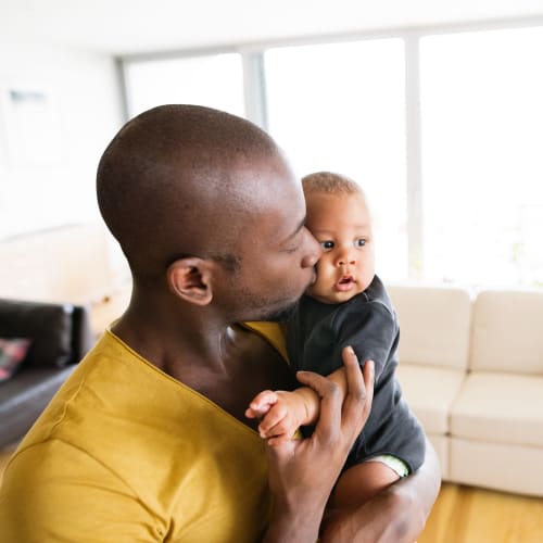 A father holding his son at JFSC in Norfolk, Virginia