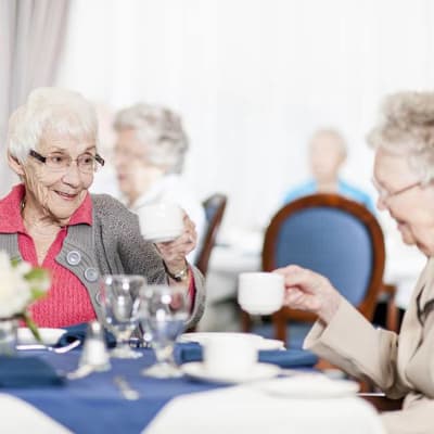Residents drinking tea in community dining room at The Renaissance of Stillwater in Stillwater, Oklahoma