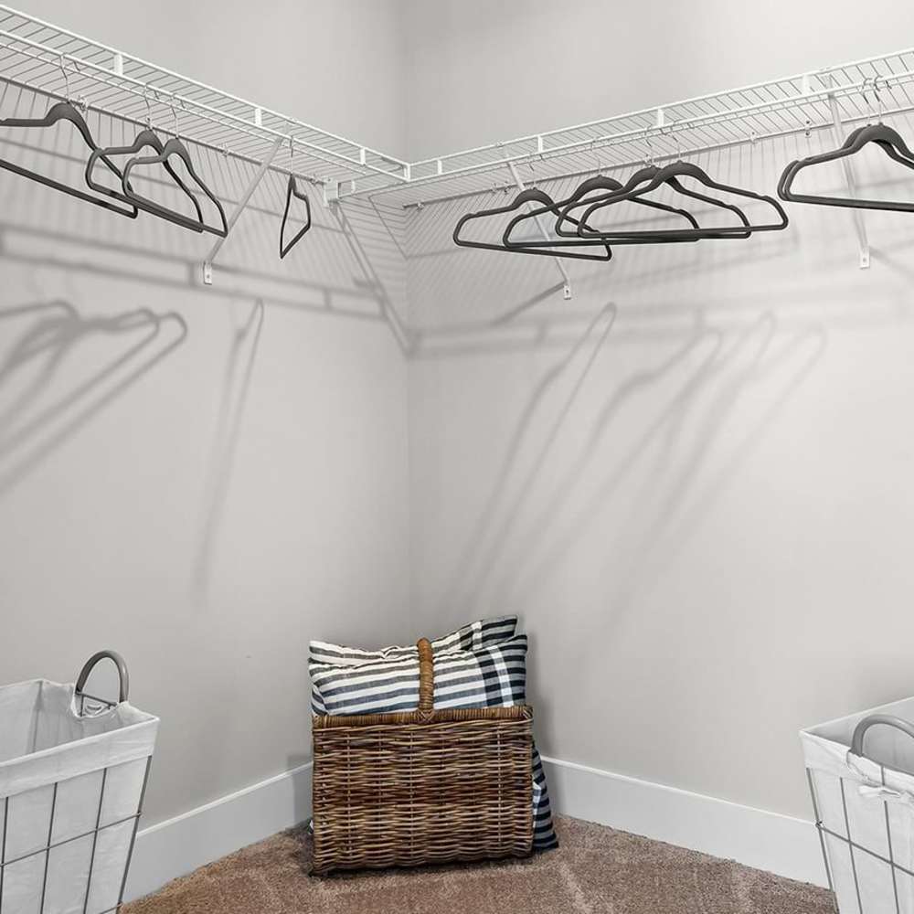 Wire shelving with hangers and a basket at Chamberlain Pines in Summerville, South Carolina