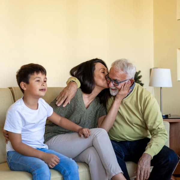 A family gathered together on a couch at Kenmore Senior Living in Kenmore, Washington