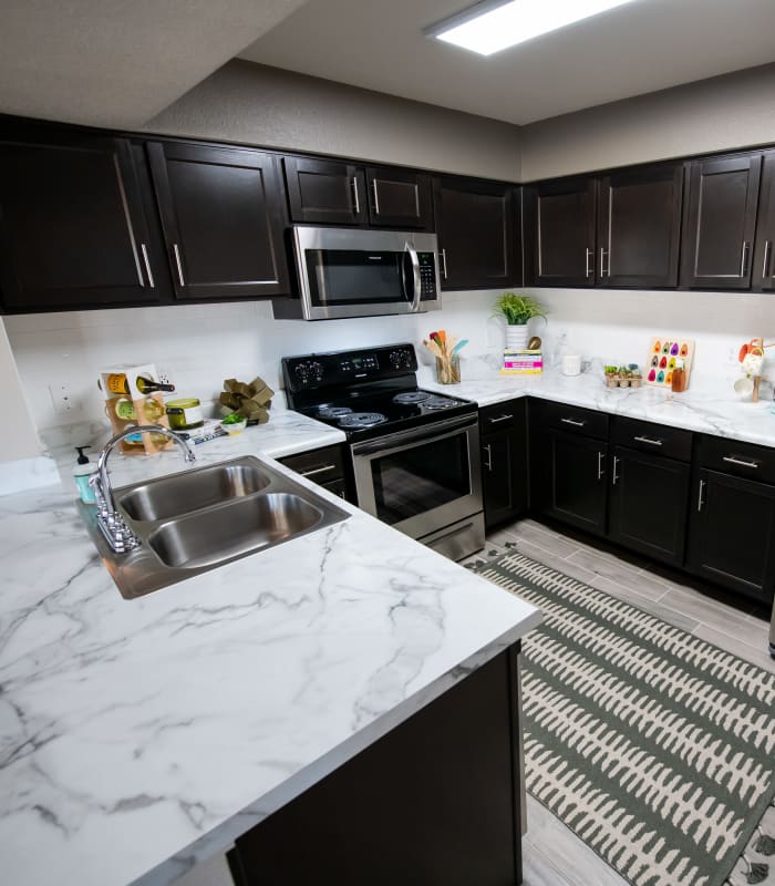 Kitchen with granite countertops at Portico at Friars Creek Apartments in Temple, Texas