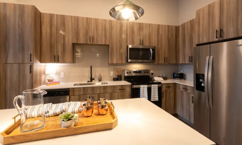 Modern kitchen with refrigerator, microwave and diswasher at The Reserve at Patterson Place in Durham, North Carolina