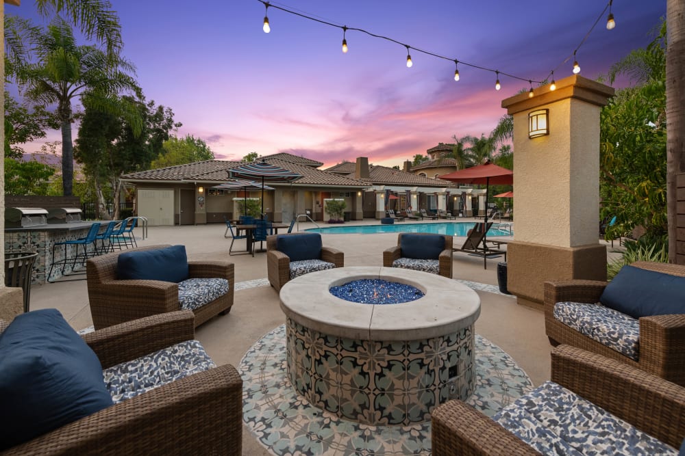 Comfortable wicker chairs around the fire pit at Sofi Westview in San Diego, California