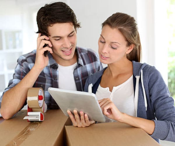 A couple looking over a tablet at Global Self Storage