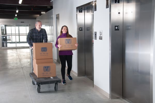 A couple moving boxes on a dolly Virginia Varsity Storage in Roanoke, Virginia