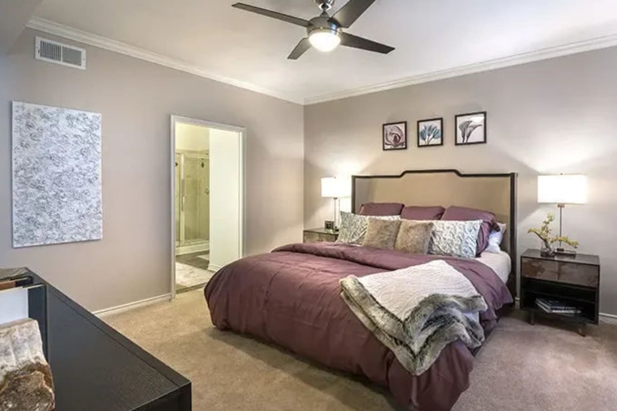 A cozy bedroom with a ceiling fan at Reserve at Stonebridge Ranch in McKinney, Texas