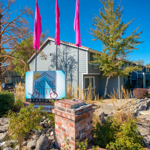 Resident woman enjoying coffee in her living room at Home Suites Apartments in Sparks, Nevada