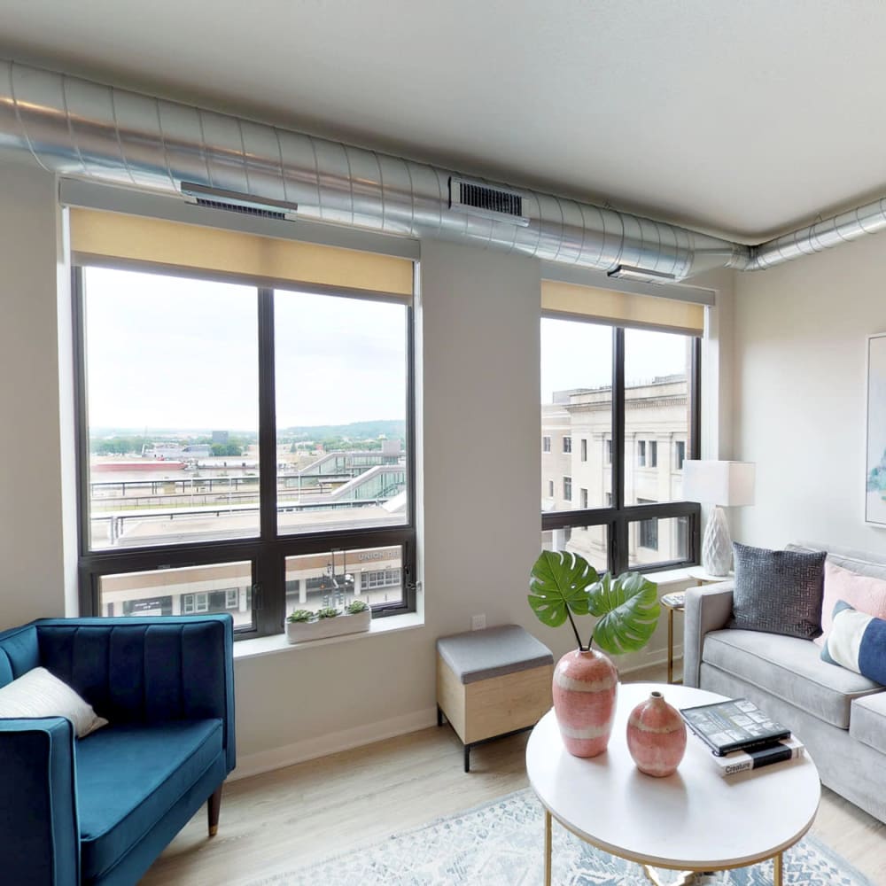 Bay windows with a terrific view of the city from a model home's well-furnished living area at Oaks Union Depot in St Paul, Minnesota