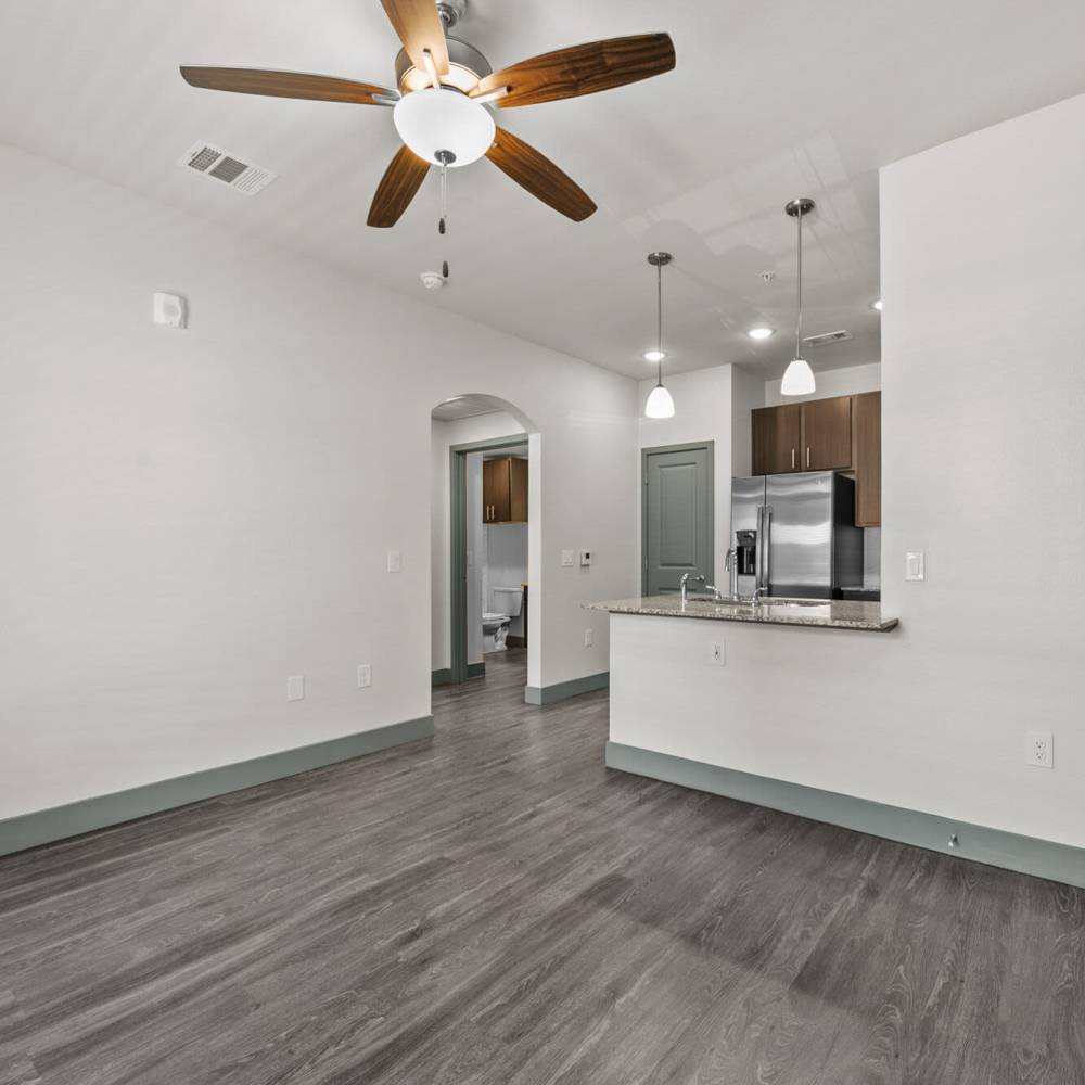 Open kitchen with ceiling fan at Cross Timbers Apartments in Greenville, Texas