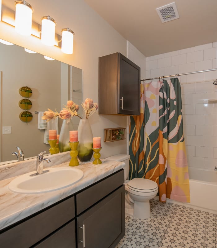 Bathroom with tile flooring at Bend at New Road Apartments in Waco, Texas