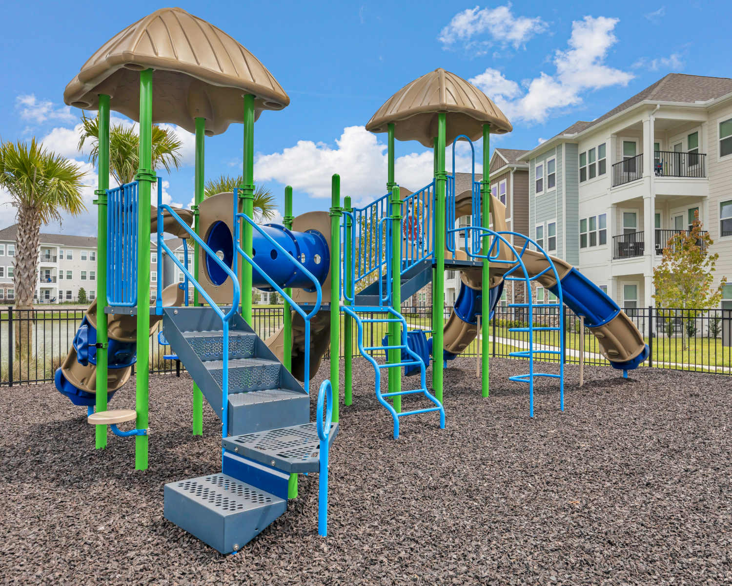 Outdoor playground with slides and climbing structures at The Carlton At Lake Dexter in Winter Haven, Florida