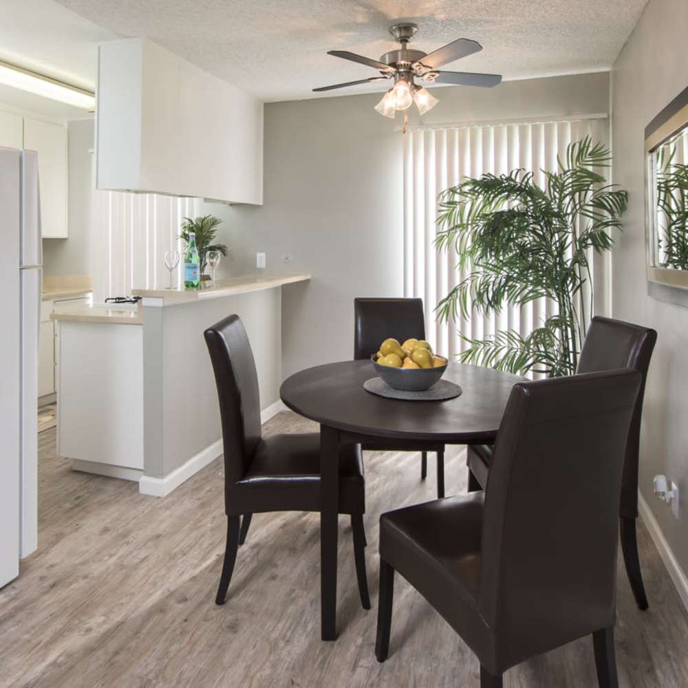 Dining area next to a kitchen in an apartment at Lawrence Road Apartments in Santa Clara, California