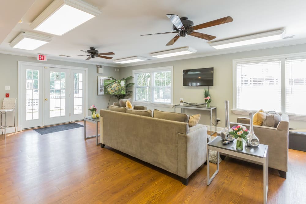 Lounge area with a wall mounted tv at Village Square Apartments in Mount Holly, New Jersey