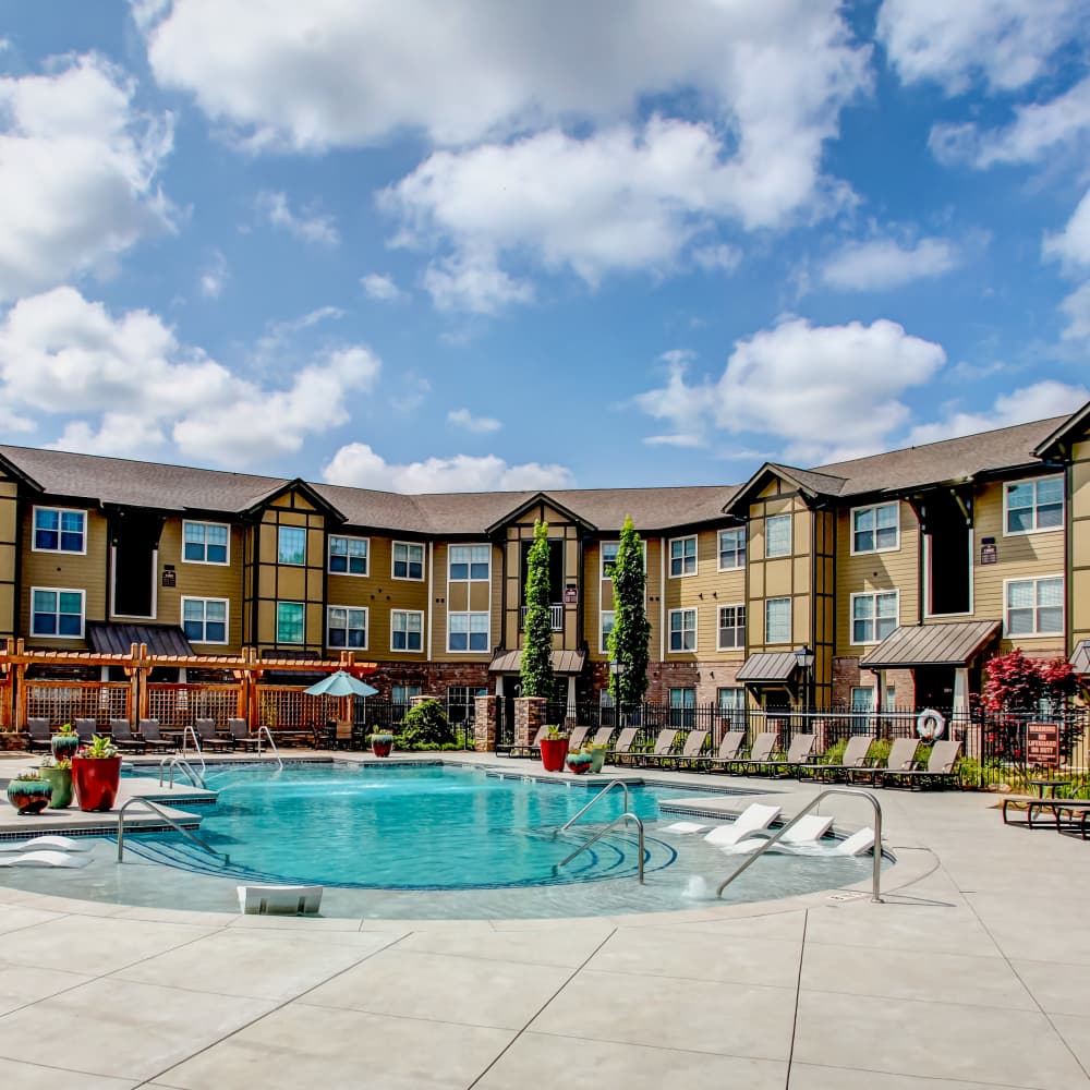 Charming resort-style pool surrounded by lush landscaping at Avonlea Square in Smyrna, Georgia.