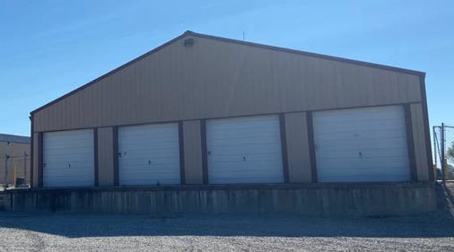 A family carrying storage boxes into their new home near KO Storage in Sedalia, Missouri