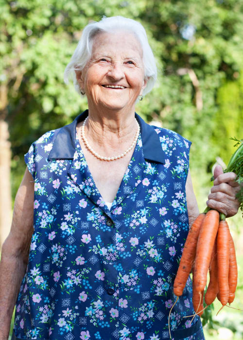 Resident holding some carrots at The Village of Southampton in Houston, Texas