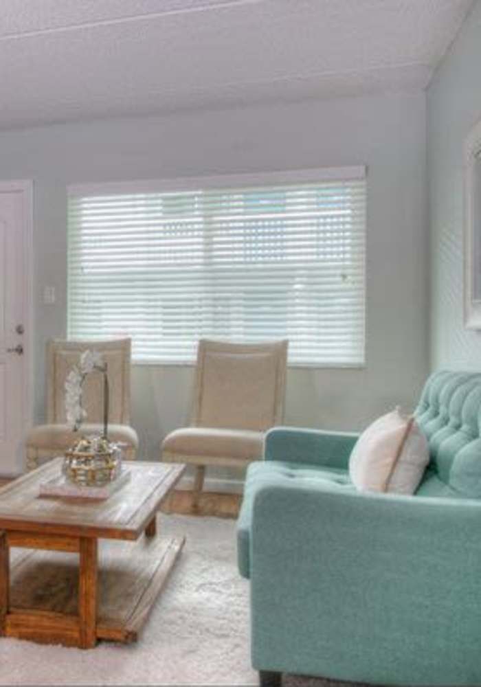 Living room with window at Bayside Villa Apartments in South Pasadena, Florida