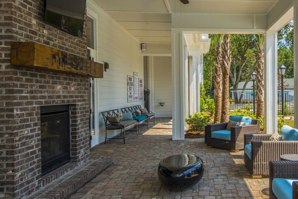 Outdoor lounge with a fireplace at Bluewater at Bolton's Landing in Charleston, South Carolina