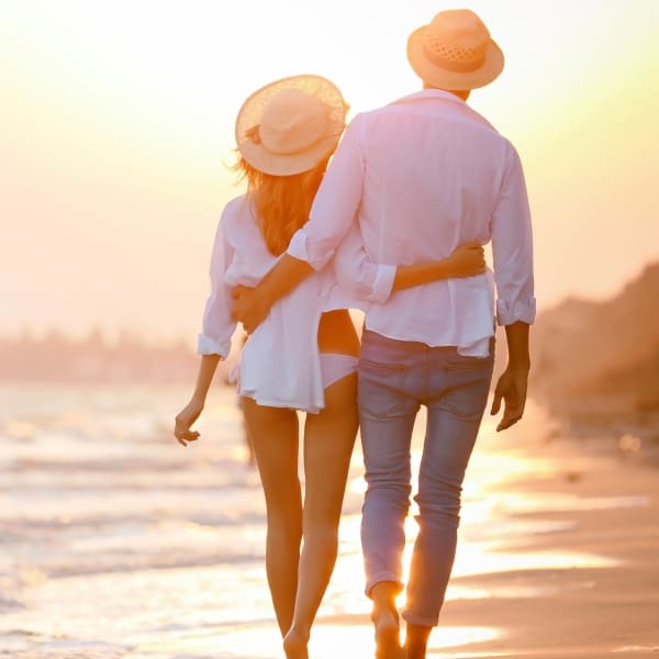 Resident couple strolling along a beach near Olympus Stone Glen in Keller, Texas