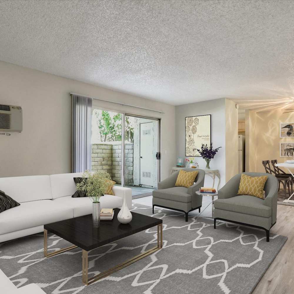 Modern living room with couch, chair and aceess to the patio at Santa Teresa Apartments in San Jose, California