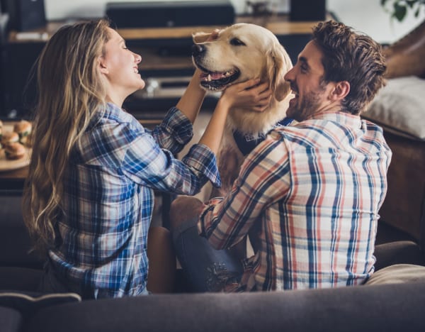Residents playing with their dog at Aventura at Richmond in Saint Peters, Missouri.