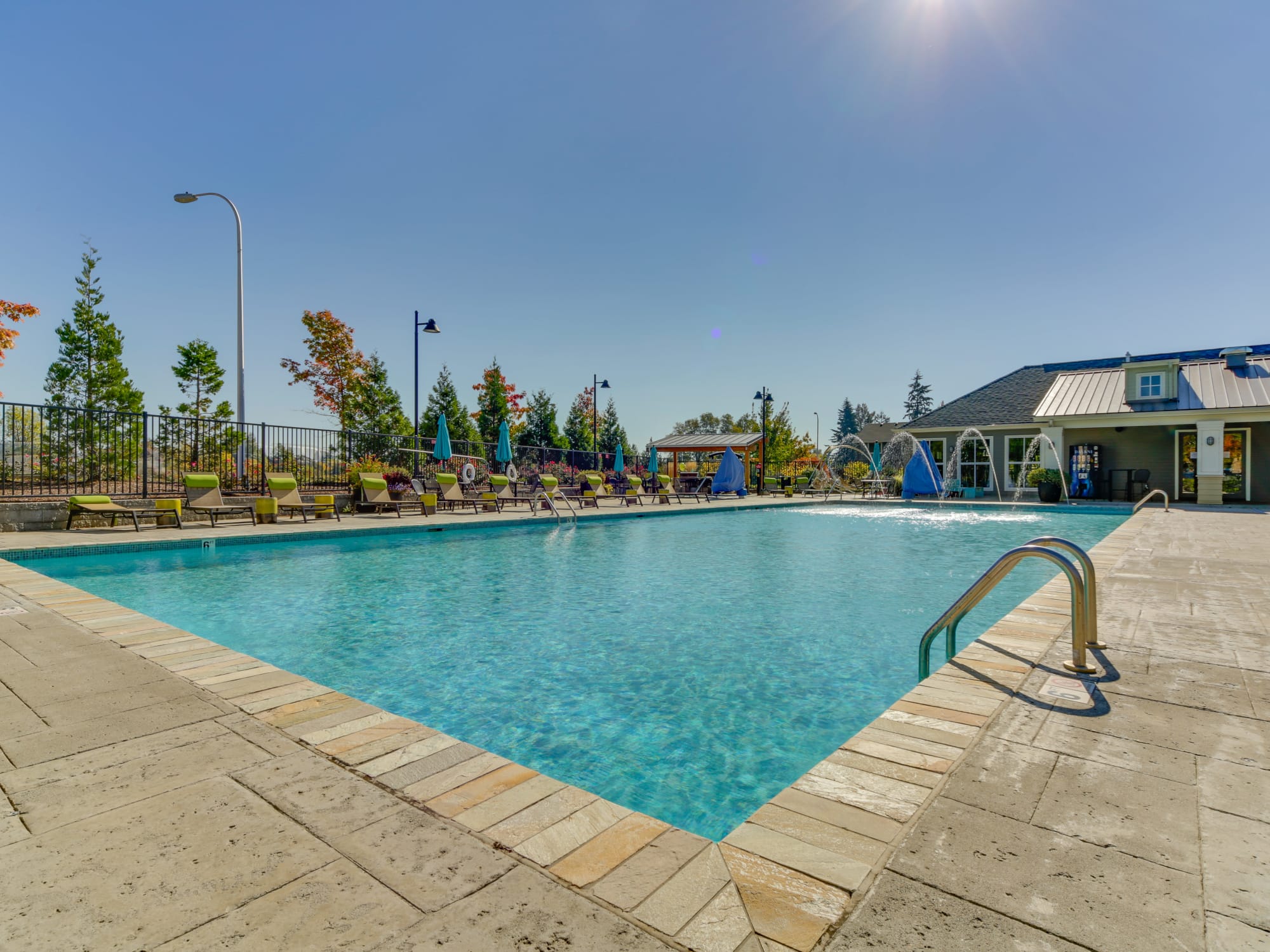 Beautiful Sparkling pool with lounges, fountains spraying into pool, spa, BBQ area in Wilsonville, OR