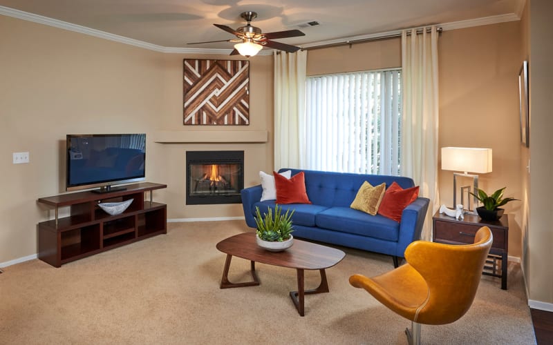 Spacious living room with a fireplace at Legend Oaks Apartments in Aurora, Colorado