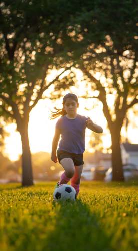 A girl playing soccer at a park near Wellshire Apartments in Denver,Colorado