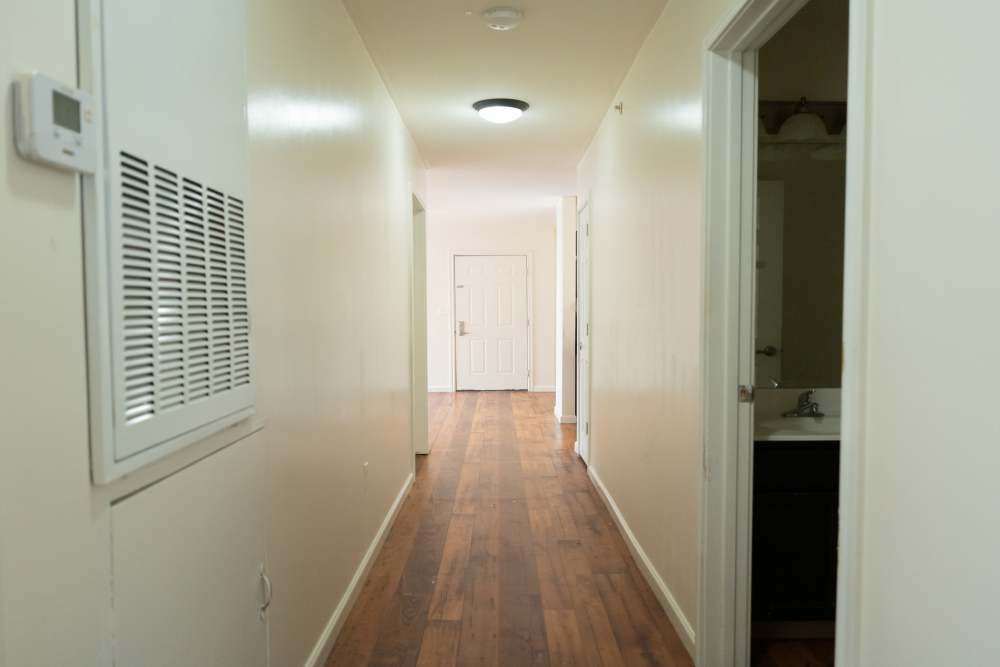 A hallway having with wooden floor at Fairway Breeze in El Reno, Oklahoma