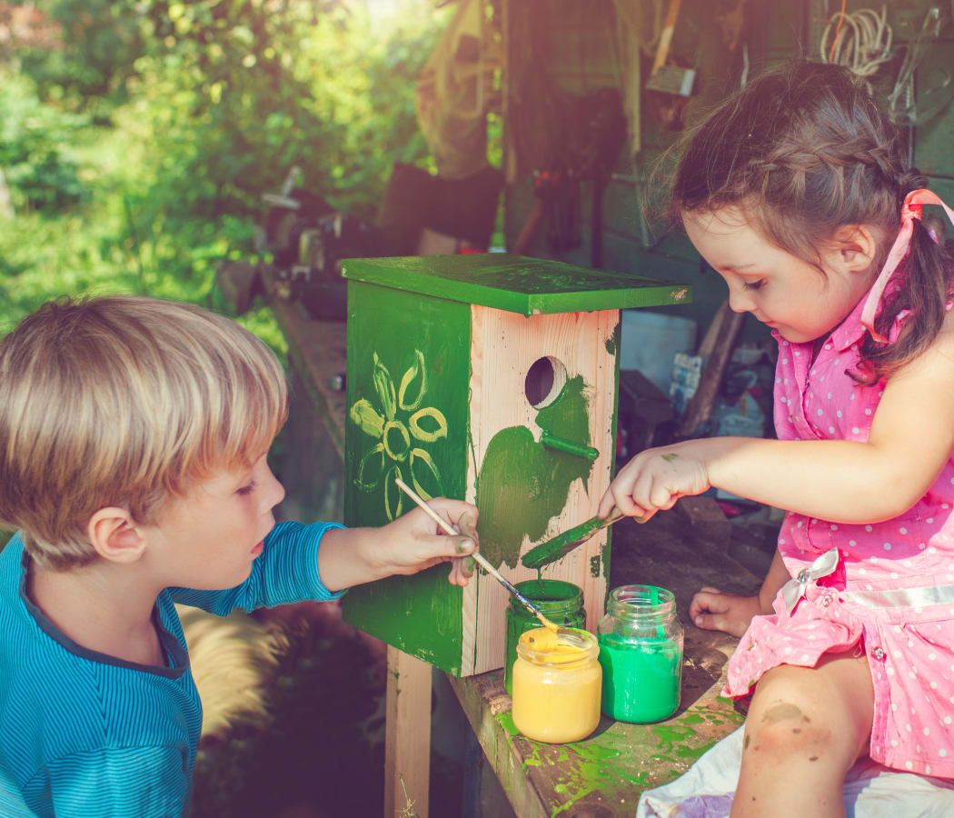 Children painting a birdhouse at Greenwoods in Brockton, Massachusetts