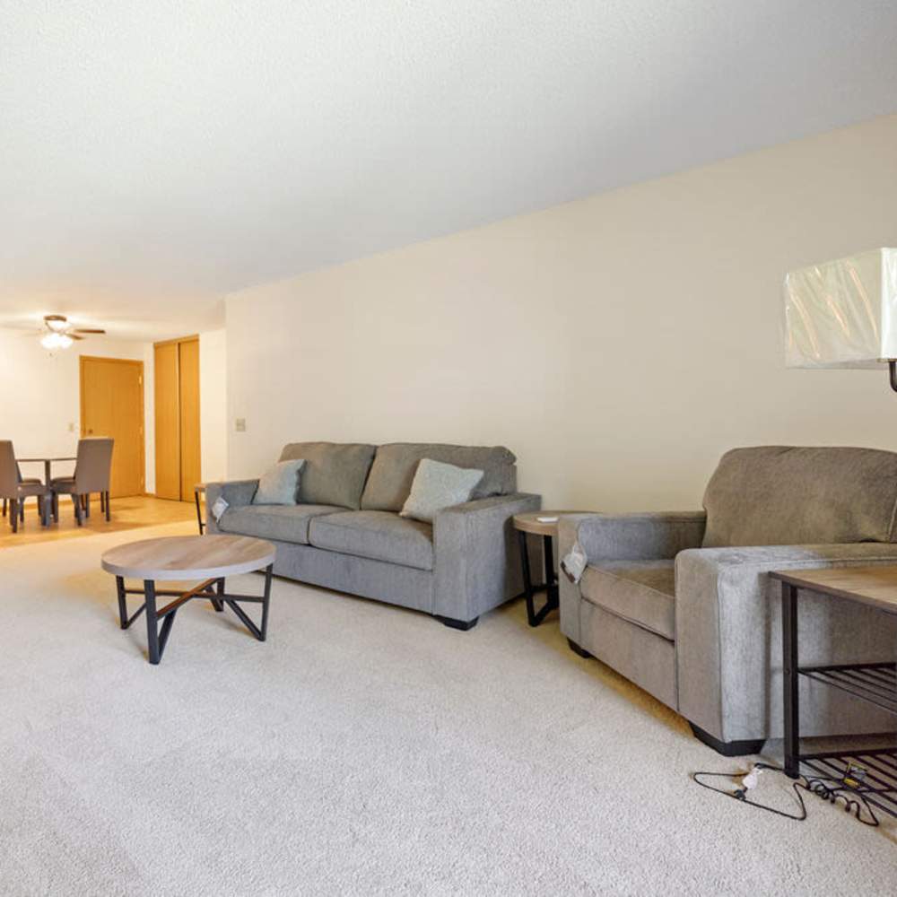 Living room connected to dining with center table at Solace on Lake Minnetonka in Spring Park, Minnesota