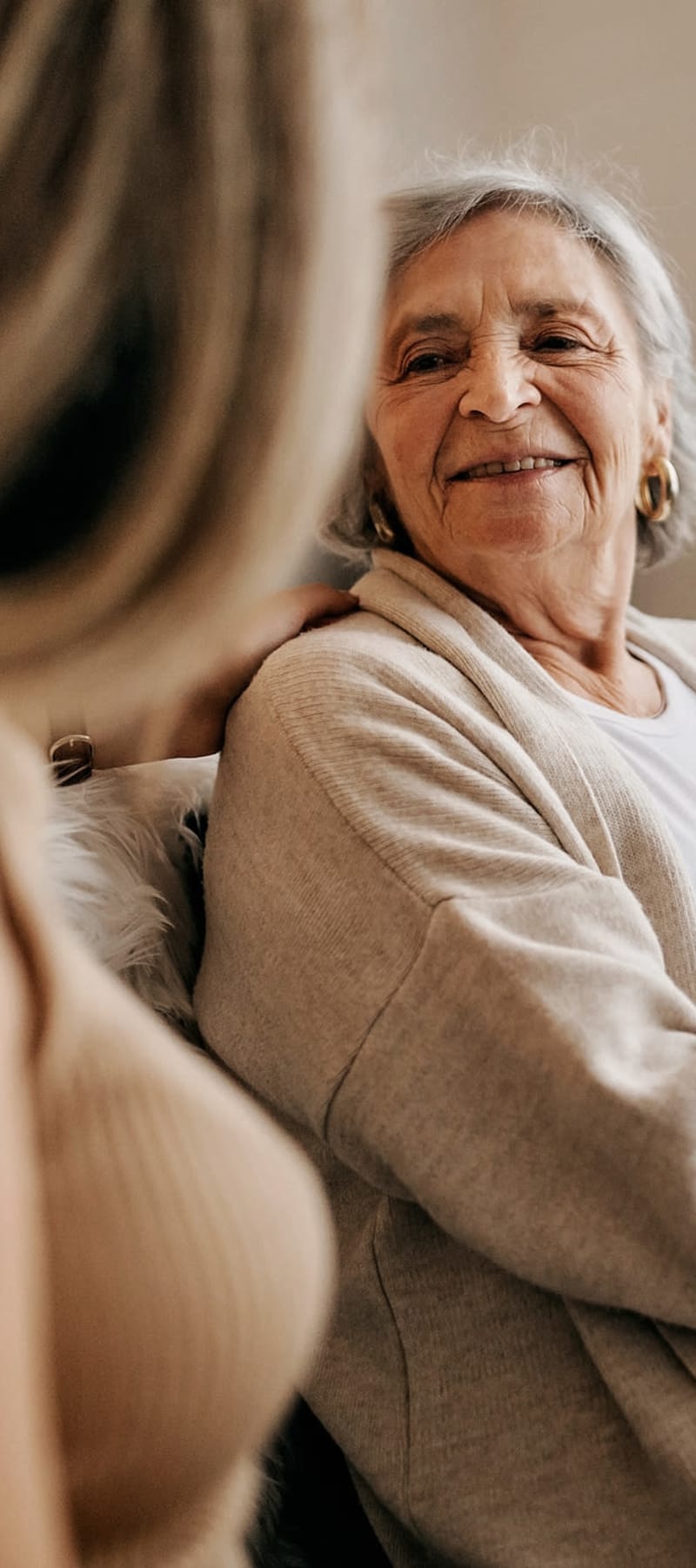 Resident sitting and talking with a care worker at a WISH community 