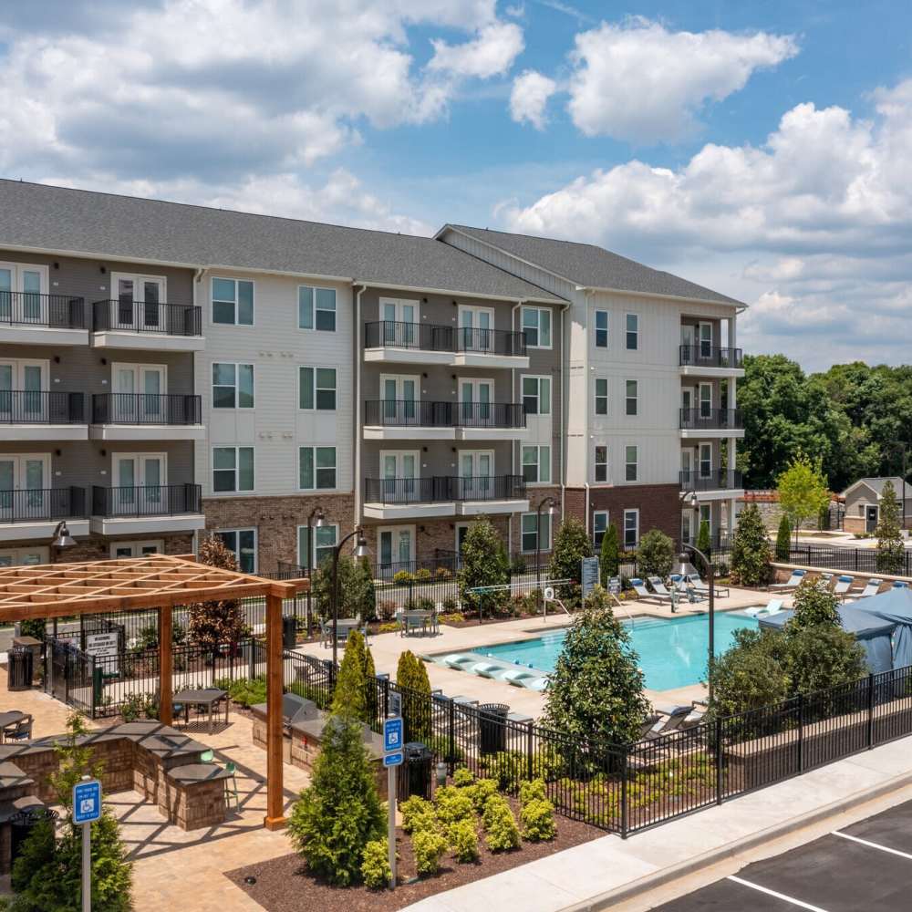 Modern pool area with seating at The Reid in Tucker, Georgia